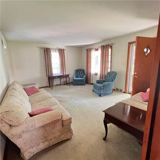 Spacious living room with a patio window