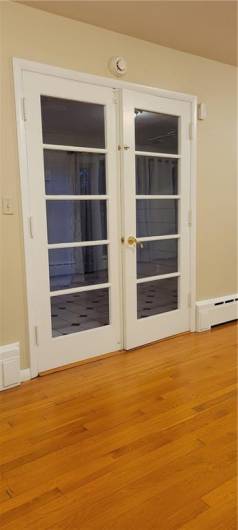 the Living Room features double doors leading into the Sun Room