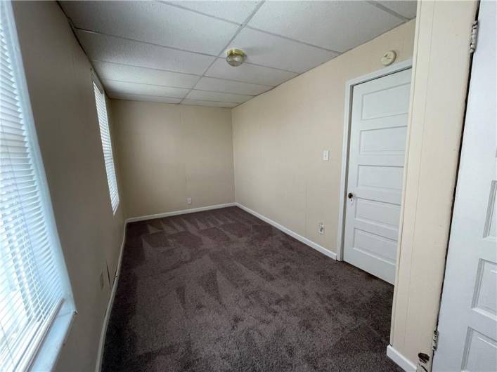 Room measures 16'x8' and has wall to wall carpet.