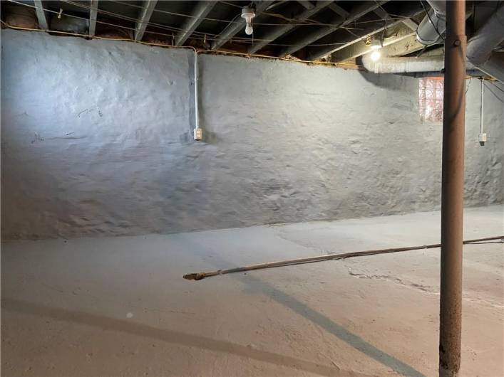 Parged and painted basement walls. Basement has a convenient working toilet.