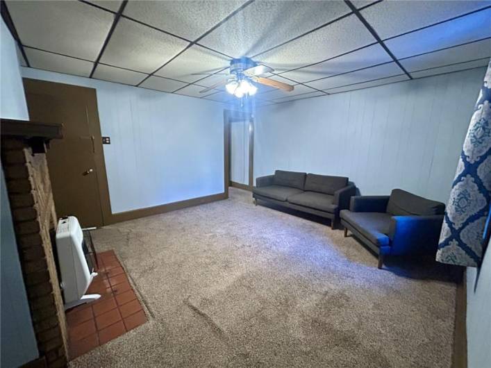 Living room area is 14x13 and couch and chair stay with unit.  Decorative Fireplace with gas heating.