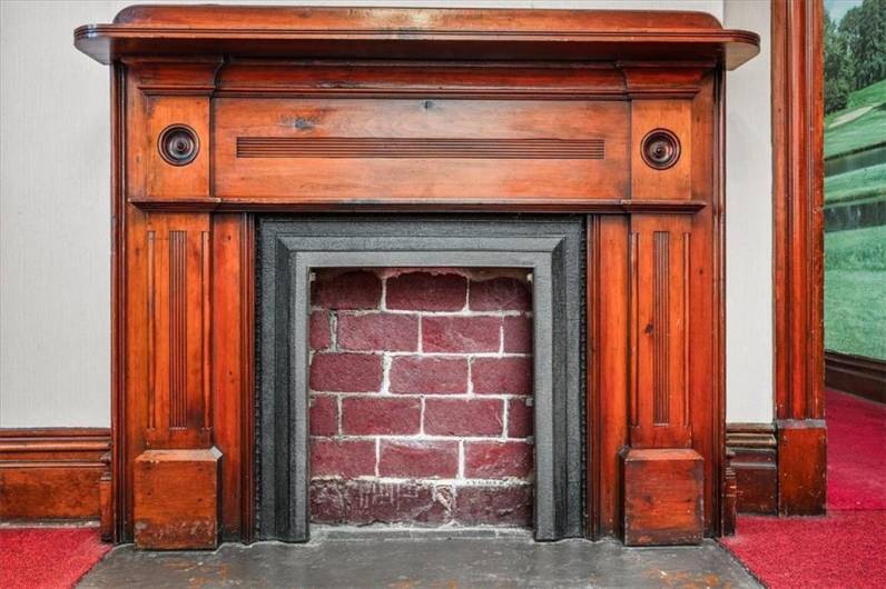 Beautiful woodwork on the decorative fireplace.