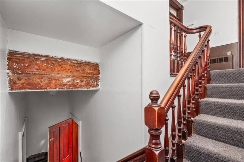 Staircase with amazing woodwork to second flor apartment.