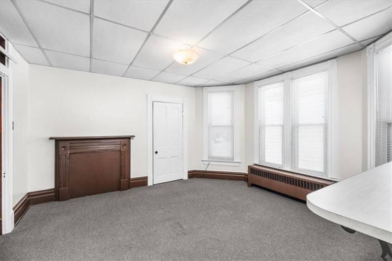 Livingroom on second floor with decorative fireplace.