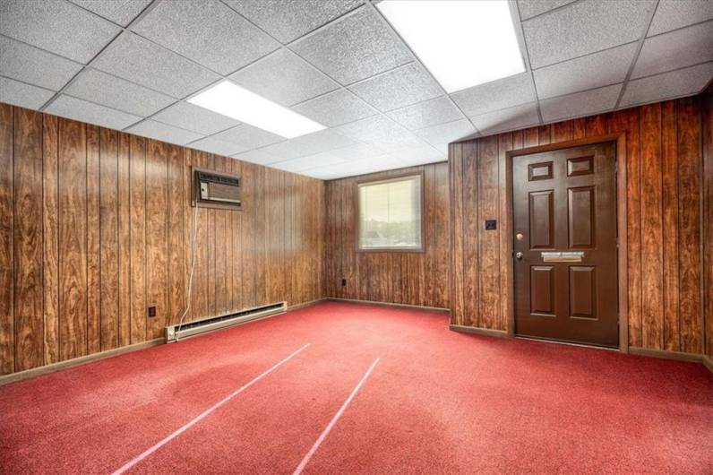 Front room is paneled and makes a great living room.