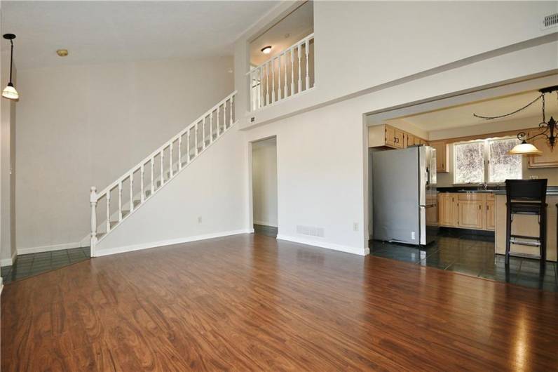 Vaulted living room open to kitchen/dining