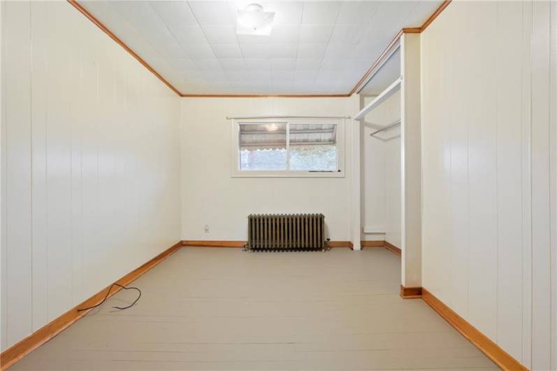 A spacious third bedroom, with walls freshly painted in neutral colors