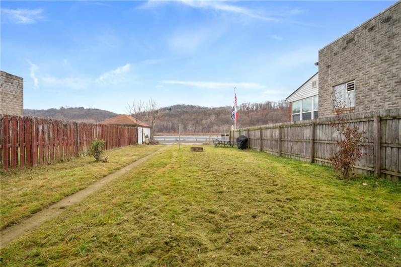 The concrete walkway leads from the off street parking spaces to the back porch, kitchen door and door to the basement