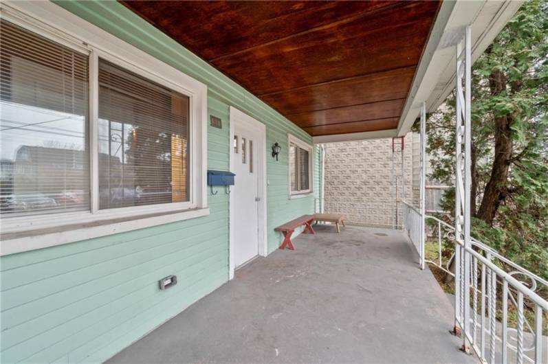 Lovely covered front porch provides a pleasant space to relax