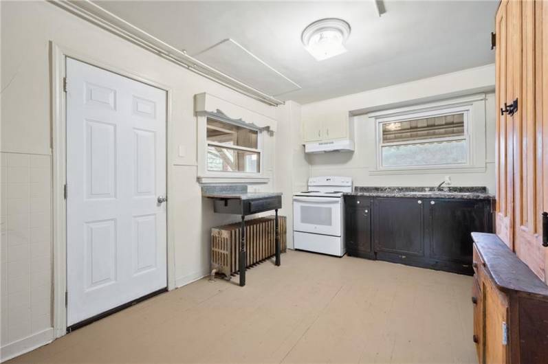 Spacious kitchen with ample storage (there's additional storage tucked behind the large vintage wooden cabinet, not shown in this photo)