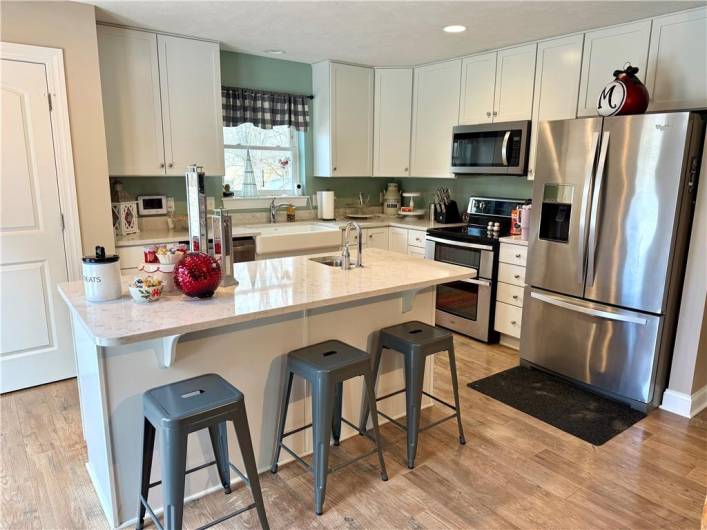 Kitchen with Island featuring a sink too.  Two Pantry areas are a plus.