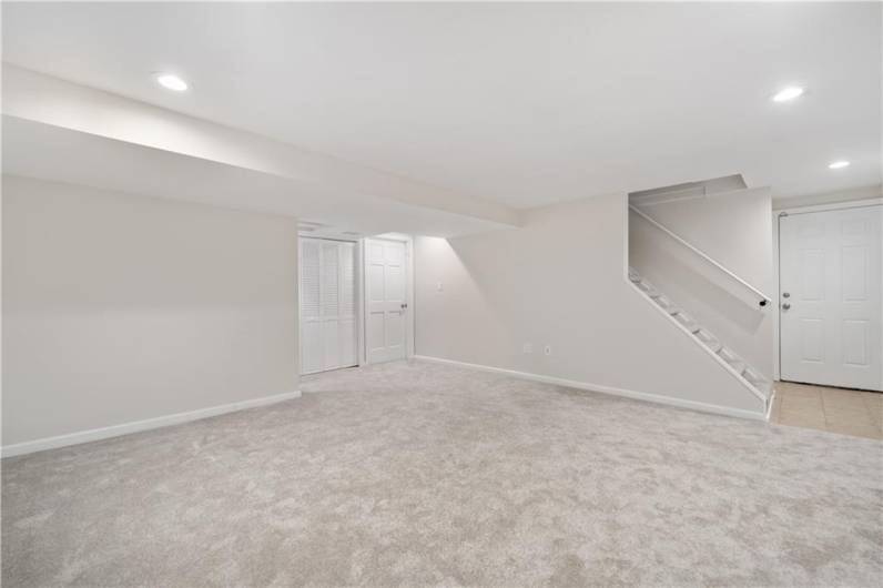 Check out this basement!!! HUGE!  So much space for your game room or another sleeping space.  New, plush carpeting, fresh paint in Sherwin Williams Aesthetic White and a brand new full bath and large laundry and storage area complete the lower level.