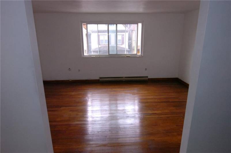 Living area in Apt. 4 showing the refinished floor.