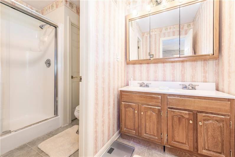 Primary bathroom with a water closet.  Double sinks and plenty of storage.