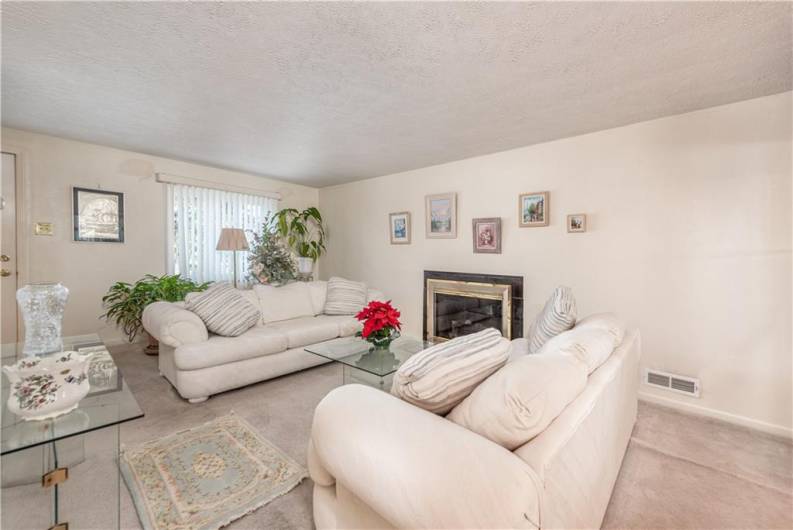 This spacious room also has a gas burning fireplace.  There are hardwood floors underneath the carpet of the original house.