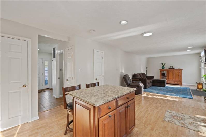 View of the tiled entryway from kitchen.  There is space for a dining area table between kitchen and family room.