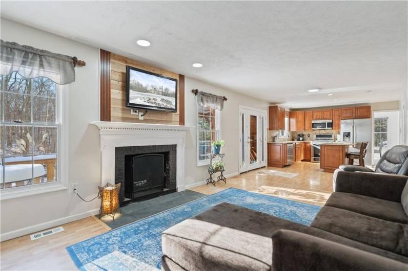 The large bright family room features a wood buring fireplace and slate hearth.