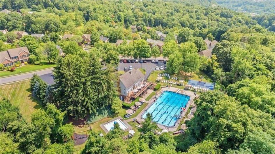 Summertime view of the Franklin Ridge community pool and club house.