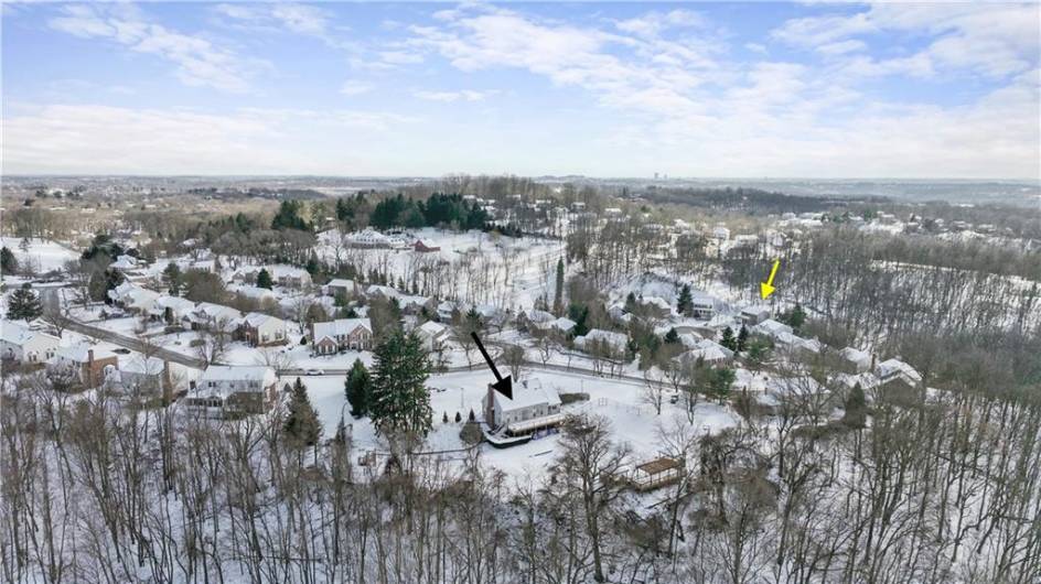 The black arrow is pointing to the community clubhouse and pool. The yellow arrow is the property.  The pool is right down the street from the home.