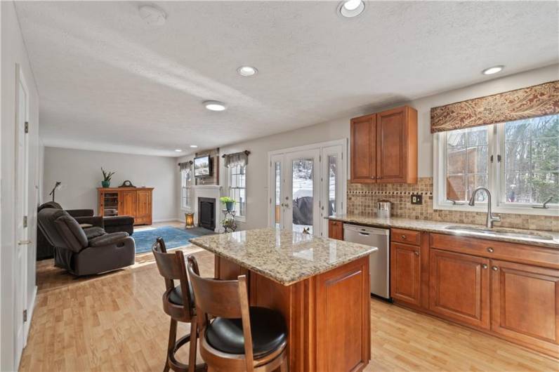 Beautiful wood cabinets, granite counters and tile backsplash adorn the kitchen.