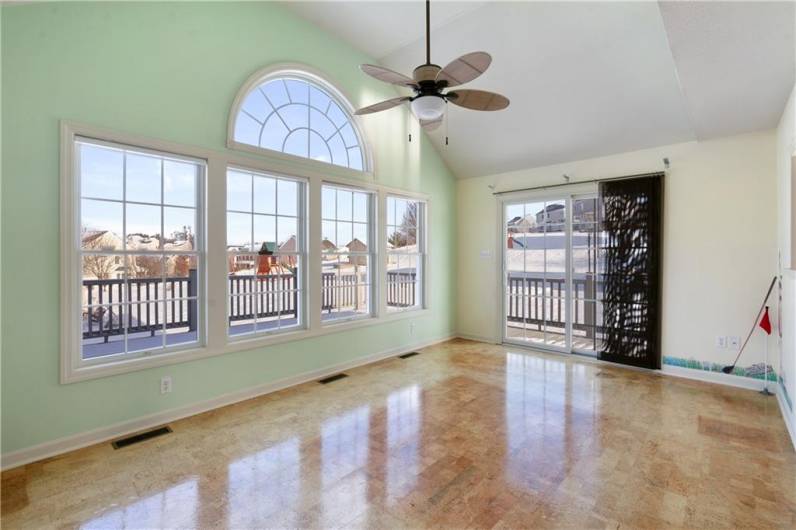 Vaulted ceilings are just one of the perks of this morning room with direct deck access.