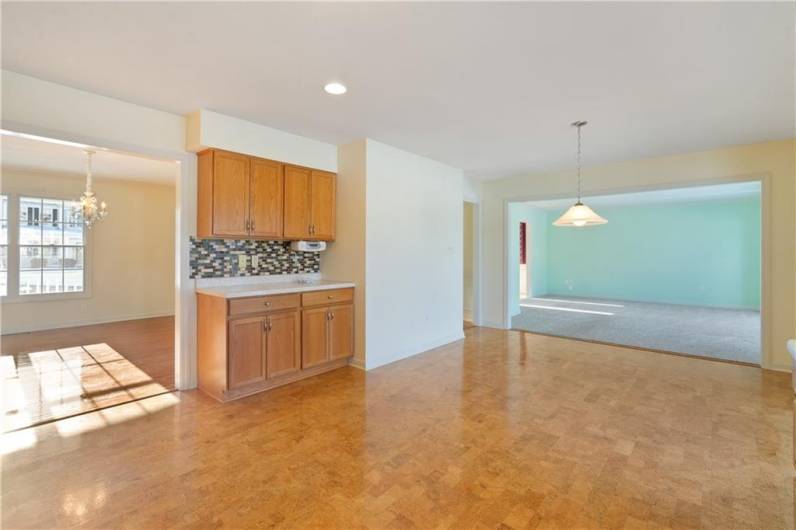 The kitchen flows into the large living room and a formal dining room.