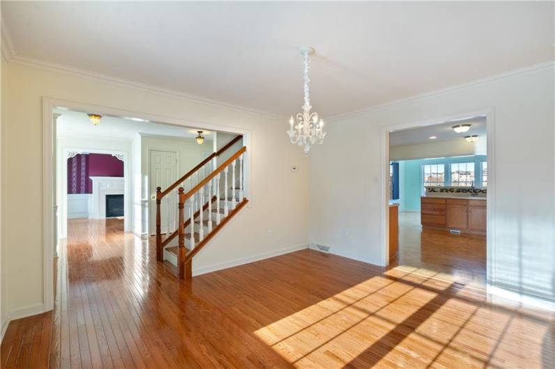 Formal dining room with beautiful hardwood flooring.