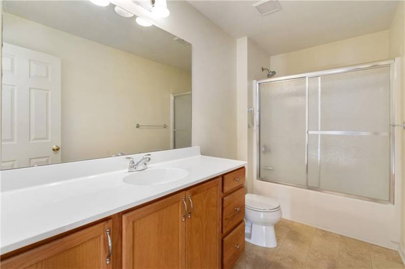 Hallway bathroom with oversized vanity.