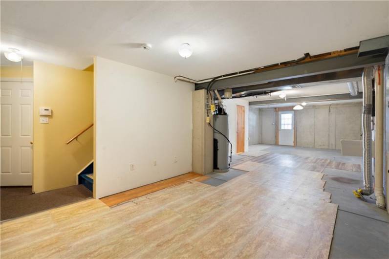 Partially finished basement with a full bath and a direct walkout to the outside patio.