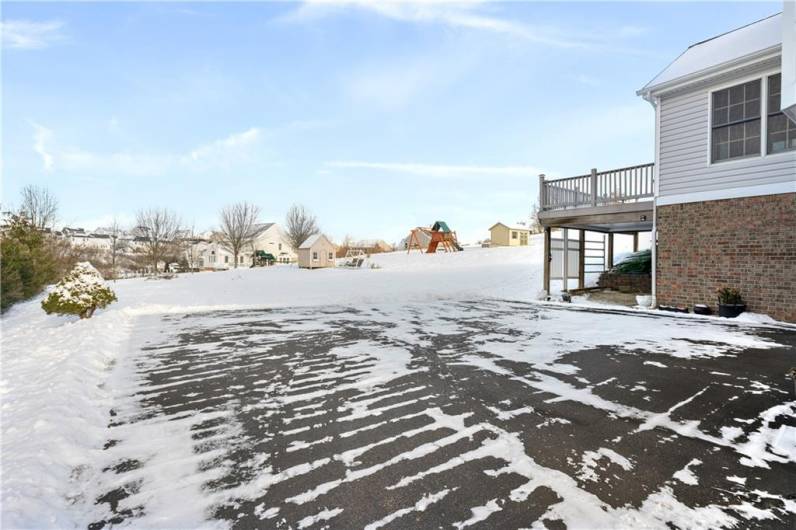 Massive driveway with plenty of parking overlooking and expansive, level backyard.