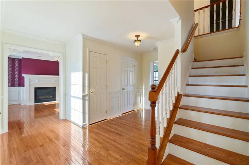 Large entryway with gleaming hardwood flooring.