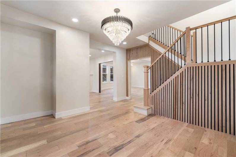 Wowza!!! Look at THIS entryway!  Engineered natural wood flooring that can also be tinted or stained to your liking.  Dramatic vertical European style woodwork lends itself to modern and chic decor.