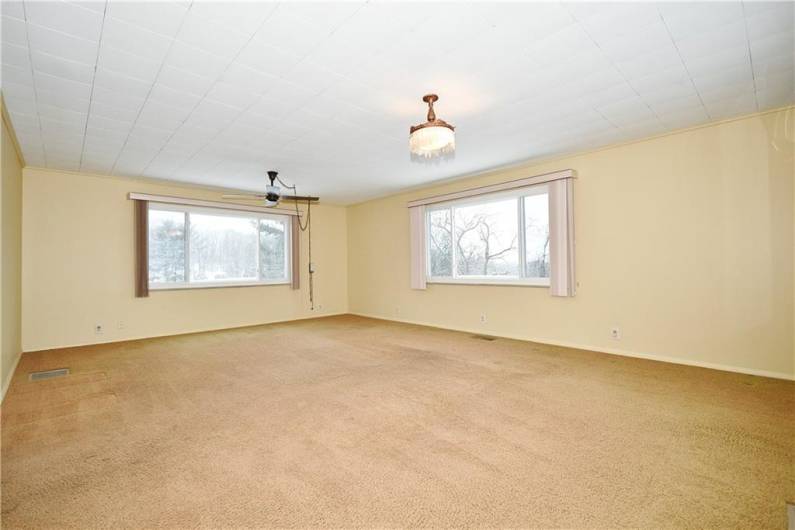 Ceiling fan, large windows and overhead light make this a great space to hang out.