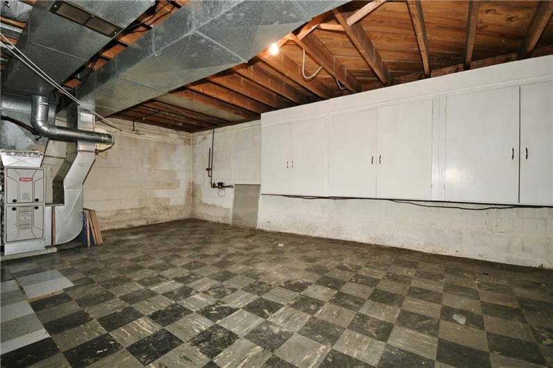 Another view of basement with built in cabinets.