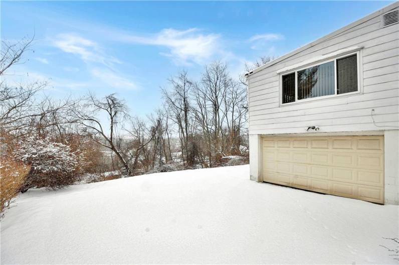 Asphalt area for access to the oversized garage and yard.