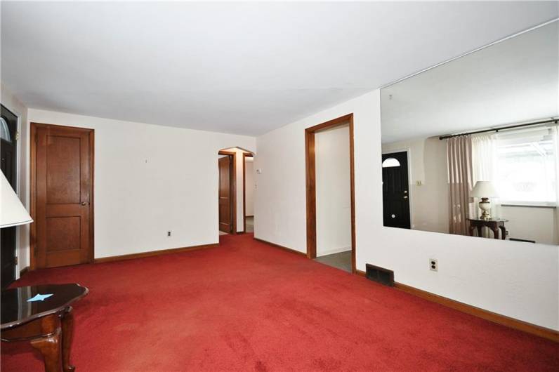 Another view. Coat closet door off to the left with access to the hallway off to the right. Opening to the kitchen.