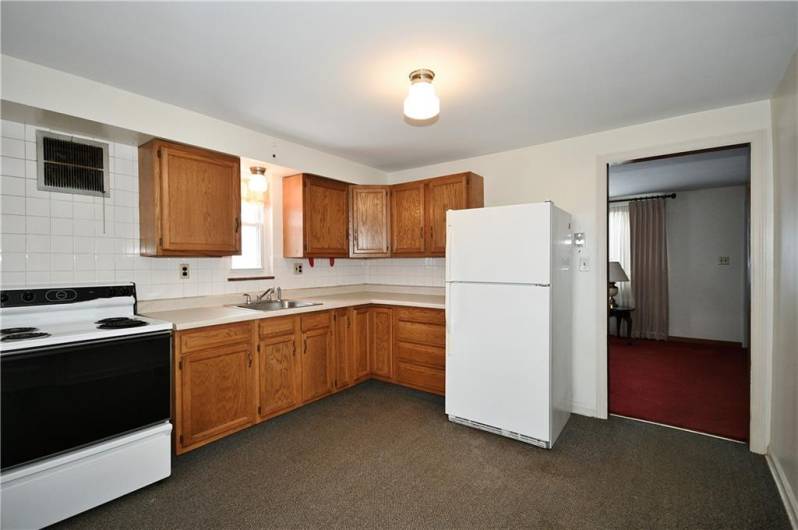 Neutral kitchen cabinets and counter. Appliances convey.