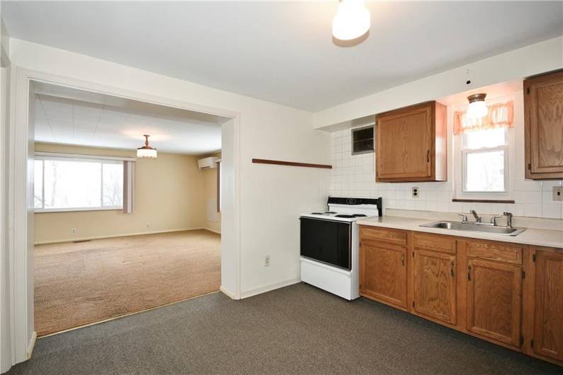 Kitchen opens to the spacious family room with large picture window.