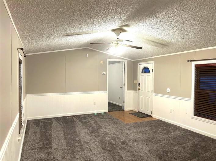 LIVING ROOM WITH OVERHEAD LIGHTING, WAINSCOTING, AND NEUTRAL COLORS!