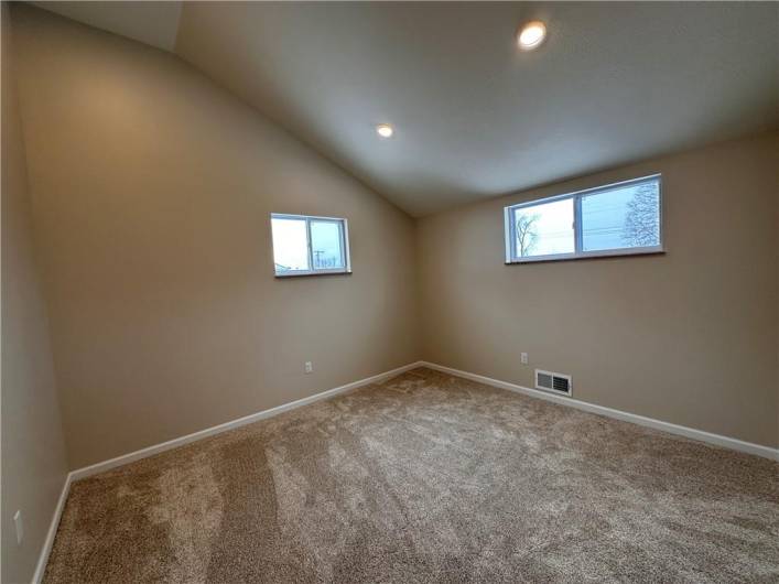 Back bedroom with new carpet, vaulted ceiling.