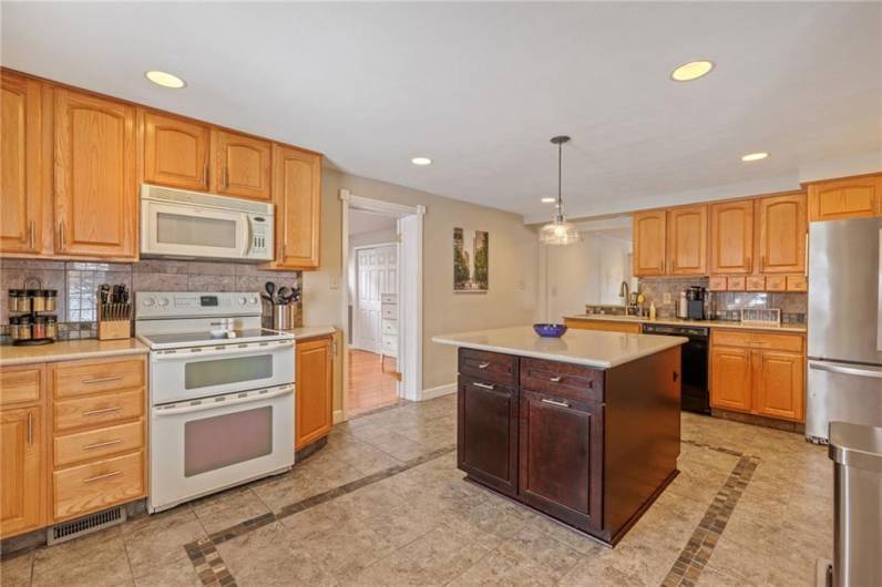 Great kitchen offering quartz countertops, solid sink and ceramic backsplash