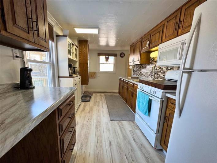 Main level kitchen, new flooring, countertops and backsplash.