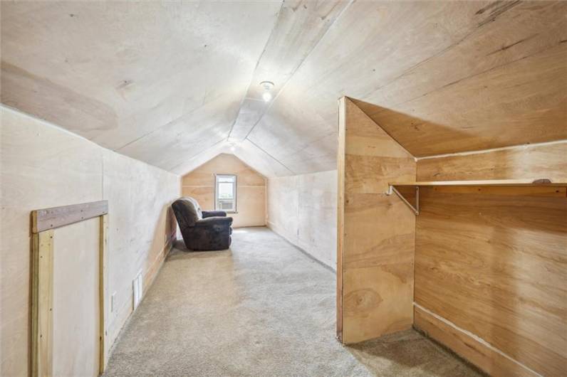 Finished attic previously used as a bedroom, could be used as office space or extra storage.