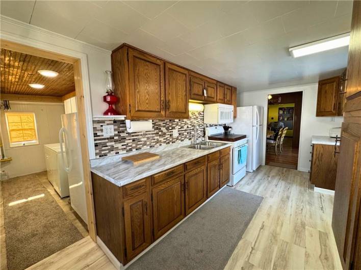 Main level kitchen, new flooring, countertops and backsplash.