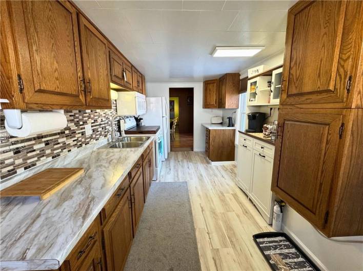 Main level kitchen, new flooring, countertops and backsplash.