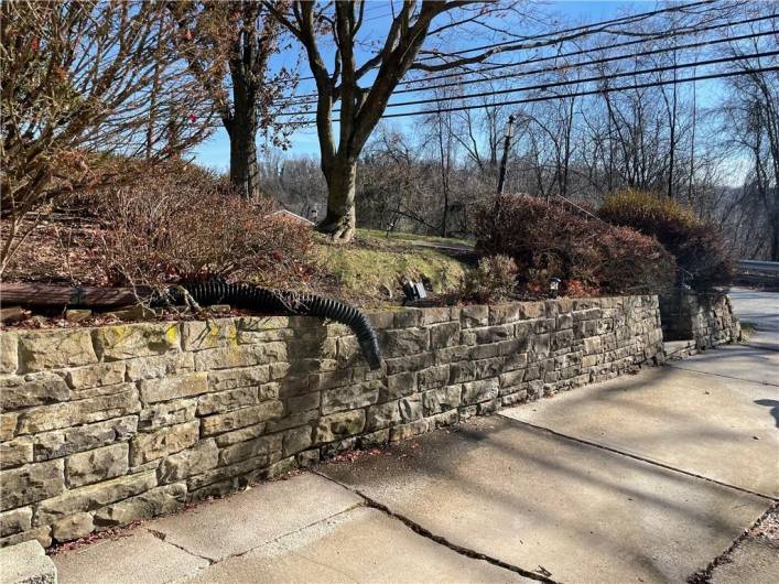 Fab stone wall extra wide driveway.