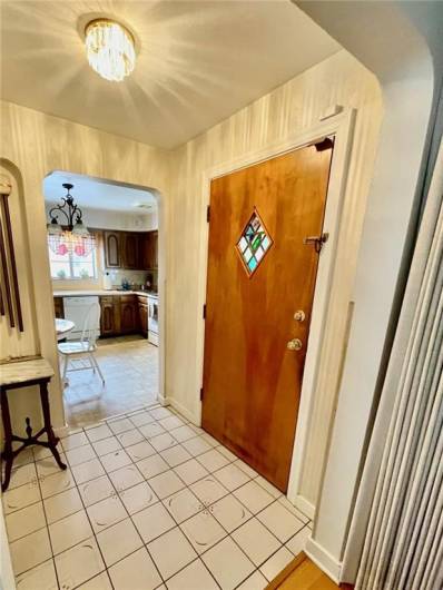 Foyer Ceramic Tile entry with leaded glass window in entry door.