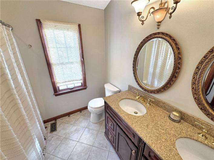 Full bath with dual vanity sinks.