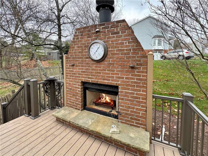 Outdoor log burning fireplace.