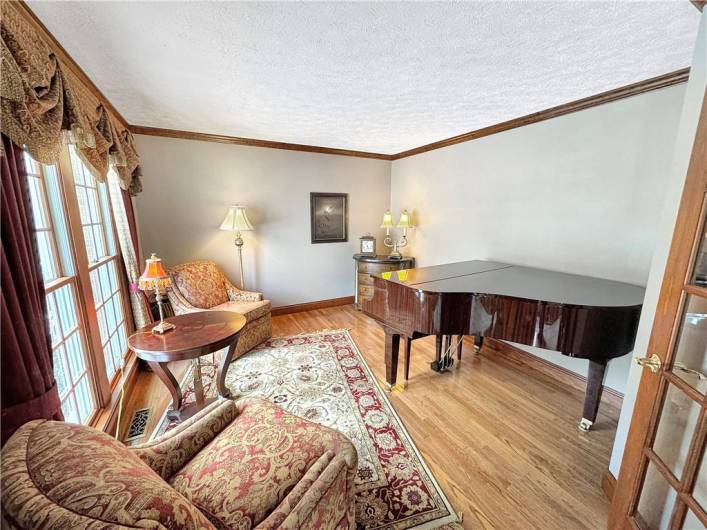 French doors lead to the living room, accented with crown moldings and hardwood floors.